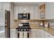 Close up of updated kitchen featuring stainless steel appliances, granite countertops, and modern cabinetry at 3736 Rainbow Cir, Snellville, GA 30039