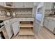 View of the kitchen showing pull-out shelves and granite countertops at 3736 Rainbow Cir, Snellville, GA 30039