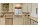 Kitchen featuring a stainless steel dishwasher, custom cabinets, granite countertops, and a mosaic backsplash at 3736 Rainbow Cir, Snellville, GA 30039