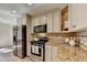 Stylish kitchen featuring stainless steel appliances, granite countertops, and a mosaic backsplash at 3736 Rainbow Cir, Snellville, GA 30039