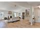 Bright living room featuring wood floors, fireplace, staircase, and comfortable seating arrangement for relaxation at 3736 Rainbow Cir, Snellville, GA 30039