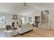 Cozy living room featuring wood floors, a fireplace, and a comfortable seating arrangement with natural light at 3736 Rainbow Cir, Snellville, GA 30039