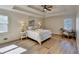 Main bedroom with tray ceiling, wood floors, and neutral paint at 3736 Rainbow Cir, Snellville, GA 30039