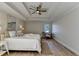 Main bedroom with tray ceiling, wood floors, and neutral paint at 3736 Rainbow Cir, Snellville, GA 30039