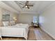 Main bedroom with tray ceiling, wood floors, and neutral paint at 3736 Rainbow Cir, Snellville, GA 30039