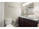 Bathroom with dark wood vanity, granite countertop, framed mirror, and decorative towels at 108 Great Oaks Lane, Roswell, GA 30075