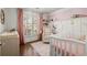 Adorable Bedroom with pink accents features a rocking chair and a white crib at 108 Great Oaks Lane, Roswell, GA 30075