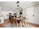 Dining room with modern light fixture and adjacent kitchen at 108 Great Oaks Lane, Roswell, GA 30075