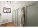 Entryway with a decorative mirror, coat hooks, and paneled wall at 108 Great Oaks Lane, Roswell, GA 30075