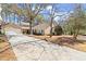 Well-manicured front lawn and mature trees surrounding this suburban home at 108 Great Oaks Lane, Roswell, GA 30075