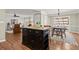 Kitchen island with granite countertop is adjacent to the dining and living area at 108 Great Oaks Lane, Roswell, GA 30075