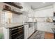 Stylish kitchen featuring stainless steel sink and appliances, with floating shelves and wine fridge at 108 Great Oaks Lane, Roswell, GA 30075