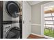 Modern laundry room with stainless steel washer and dryer at 108 Great Oaks Lane, Roswell, GA 30075