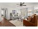 Comfortable living room with hardwood floors, ceiling fan, and neutral paint palette throughout at 108 Great Oaks Lane, Roswell, GA 30075