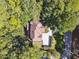 Aerial view of home highlighting the roof, driveway, landscaping, and surrounding greenery at 1678 Valor Ridge Nw Dr, Kennesaw, GA 30152