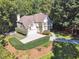 Aerial view of home showcasing the landscaped yard, long driveway, and surrounding greenery at 1678 Valor Ridge Nw Dr, Kennesaw, GA 30152