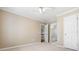 A bright bedroom features neutral carpet and a view to the stairwell and bathroom at 1678 Valor Ridge Nw Dr, Kennesaw, GA 30152