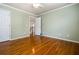 Bright bedroom with hardwood floors, ceiling fan and view to stairwell at 1678 Valor Ridge Nw Dr, Kennesaw, GA 30152