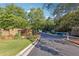 An inviting entrance to the community, featuring lush landscaping, colorful flowers, and a stately brick sign at 1678 Valor Ridge Nw Dr, Kennesaw, GA 30152