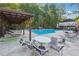 Resort-style pool area features lounge chairs, tables, and a covered pavilion for relaxation and entertainment at 1678 Valor Ridge Nw Dr, Kennesaw, GA 30152