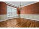 Formal dining room with hardwood floors, wainscoting, and a large window at 1678 Valor Ridge Nw Dr, Kennesaw, GA 30152