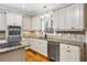 Updated kitchen featuring stainless appliances, granite countertops, and backsplash at 1678 Valor Ridge Nw Dr, Kennesaw, GA 30152