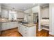 Modern kitchen with white cabinets, granite countertops, and a center island at 1678 Valor Ridge Nw Dr, Kennesaw, GA 30152