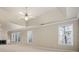 Large main bedroom featuring a tray ceiling, fireplace, and multiple windows at 1678 Valor Ridge Nw Dr, Kennesaw, GA 30152