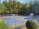 Two well-maintained tennis courts are surrounded by lush greenery and a black fence at 1678 Valor Ridge Nw Dr, Kennesaw, GA 30152