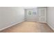 Empty bedroom with carpet, window, and closet space ready for customization at 3250 N Embry Cir, Atlanta, GA 30341