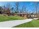 Brick home with long driveway leading up to the main house with lush green landscaping at 3250 N Embry Cir, Atlanta, GA 30341