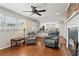 Comfortable living room showcasing a brick fireplace, ceiling fan, and hardwood floors at 3250 N Embry Cir, Atlanta, GA 30341