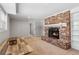 Cozy carpeted living room with a brick fireplace and wooden table at 3250 N Embry Cir, Atlanta, GA 30341