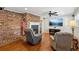 Cozy living room features hardwood floors, a ceiling fan, and a brick fireplace at 3250 N Embry Cir, Atlanta, GA 30341