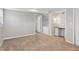 Spacious carpeted room featuring neutral walls, built-in shelves, and a closet at 3250 N Embry Cir, Atlanta, GA 30341