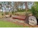 Landscaped backyard featuring a wooden platform, gravel, and a charming seating area surrounded by greenery at 761 Bellemeade Nw Ave, Atlanta, GA 30318