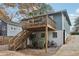 Exterior view featuring a two-story deck with stairs, plus a gravel yard and driveway at 761 Bellemeade Nw Ave, Atlanta, GA 30318