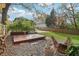 Landscaped backyard featuring a wooden platform, gravel, a manicured lawn and seating area at 761 Bellemeade Nw Ave, Atlanta, GA 30318