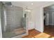 Bathroom featuring a walk-in shower, wood floors, and light fixtures at 761 Bellemeade Nw Ave, Atlanta, GA 30318