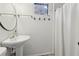 Clean bathroom featuring a pedestal sink, round mirror, and shower with a white curtain at 761 Bellemeade Nw Ave, Atlanta, GA 30318