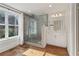 Modern bathroom showcasing a frameless glass shower, stylish vanity, and large window for natural light at 761 Bellemeade Nw Ave, Atlanta, GA 30318