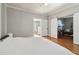 Bedroom featuring hardwood floors, sliding barn door, and view to bathroom at 761 Bellemeade Nw Ave, Atlanta, GA 30318