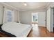 Bedroom featuring hardwood floors, a window and sliding barn door at 761 Bellemeade Nw Ave, Atlanta, GA 30318