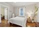 Cozy bedroom with hardwood floors, white walls, ceiling fan, and bright window for natural light at 761 Bellemeade Nw Ave, Atlanta, GA 30318