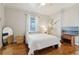 Bright bedroom featuring hardwood floors, neutral walls, a ceiling fan, and a television at 761 Bellemeade Nw Ave, Atlanta, GA 30318