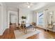 Well-lit dining area with hardwood floors, a brick fireplace, and modern furnishings at 761 Bellemeade Nw Ave, Atlanta, GA 30318