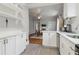 Galley kitchen with white cabinets and view to dining room with brick fireplace at 761 Bellemeade Nw Ave, Atlanta, GA 30318