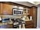 Kitchen featuring stainless steel appliances, granite counter tops and wooden cabinets at 1013 Canyon Point Cir, Roswell, GA 30076