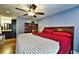 Comfortable main bedroom with en suite bathroom, ceiling fan, and beautiful hardwood floors at 1013 Canyon Point Cir, Roswell, GA 30076