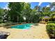 Community pool with a nearby gazebo, multiple lounge chairs, blue umbrellas, trees for shade, and a shallow end with stairs at 1013 Canyon Point Cir, Roswell, GA 30076